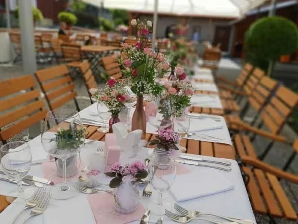 Liebevolle Tischdekoration mit Wiesenblumen in Rosé und Schleierkraut